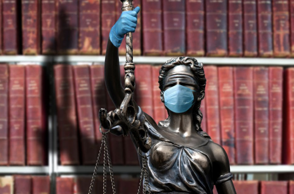 A statue wears PPE in the form of gloves and a face mask.