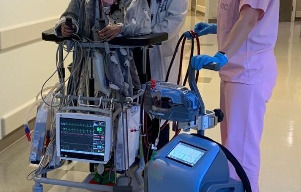 Patient walking with Breethe breathing machine.