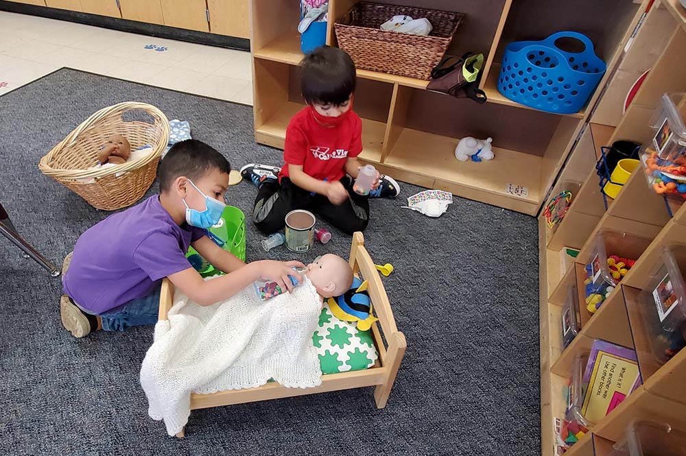 Two children practice executive functioning skills with toys.