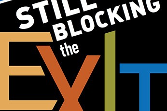 words that say, "Still blocking the exit"