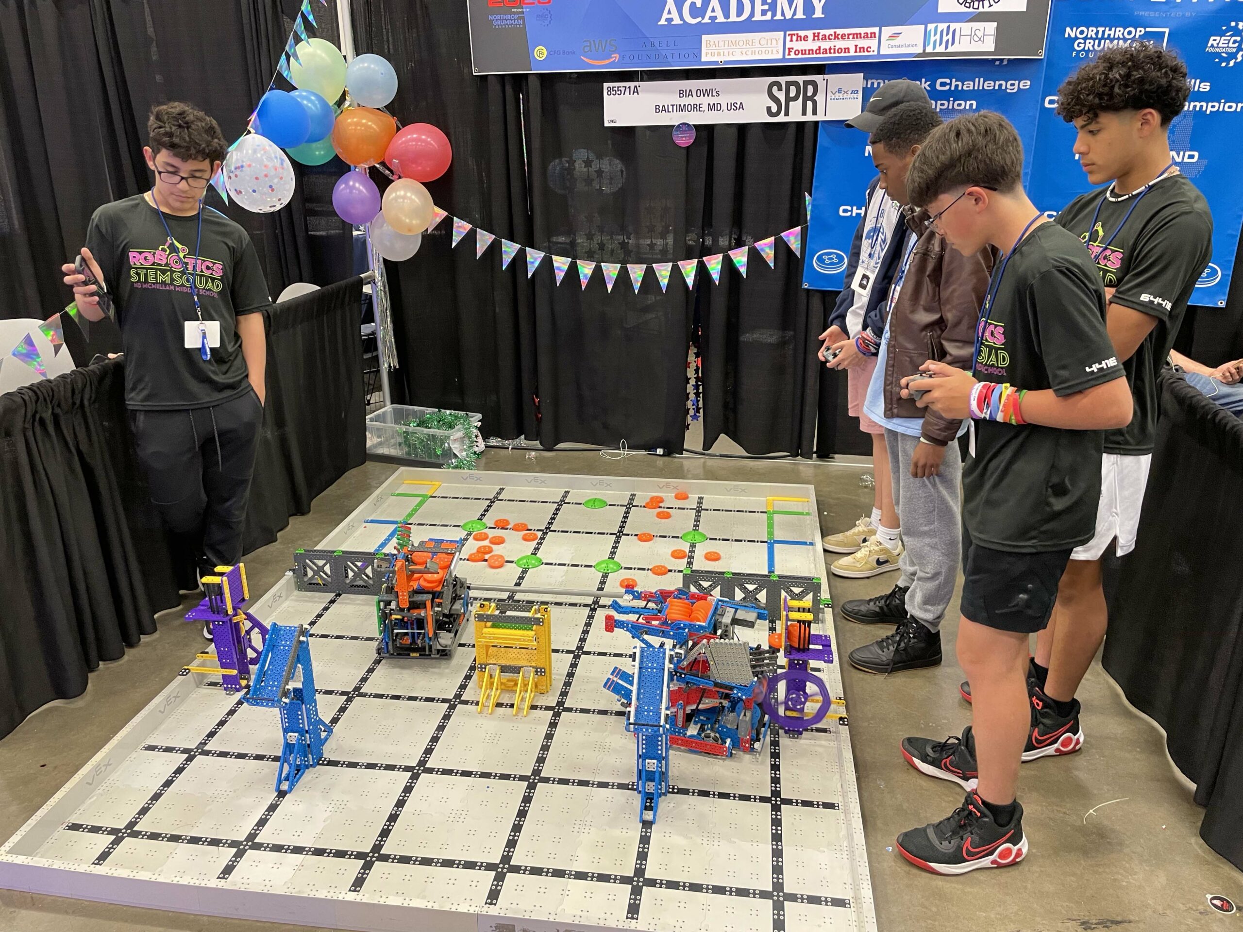 Students watch their robots.